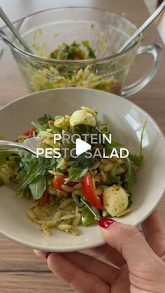 a person is holding a bowl with food in it and the words protein pest salad