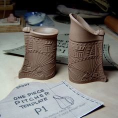 two clay shoes sitting on top of a table