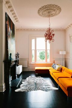 a living room filled with furniture and a chandelier