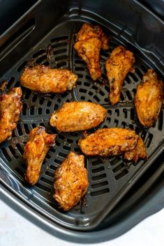 chicken wings cooking in an air fryer