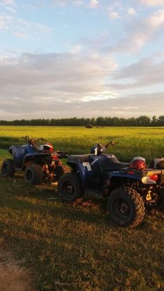 two atvs parked in the grass near each other