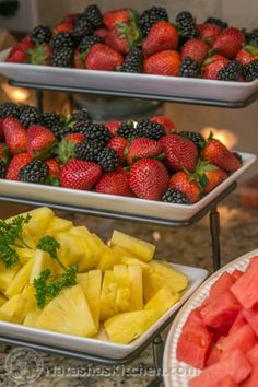 three tiered trays filled with different types of fruit