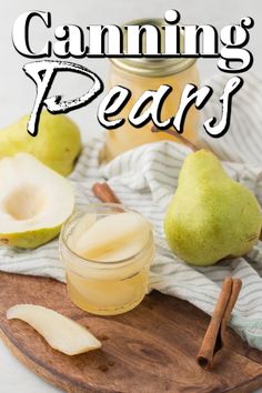 a wooden cutting board topped with sliced pears next to a jar of apple cider