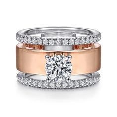 two wedding rings with diamonds on each band and one diamond in the middle, set against a white background