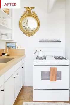 a white stove top oven sitting inside of a kitchen next to a wooden countertop