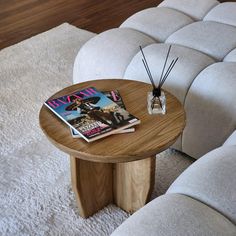 a wooden table sitting on top of a white rug