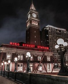 a large clock tower towering over a city at night