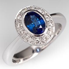 a ring with a blue stone surrounded by white diamonds