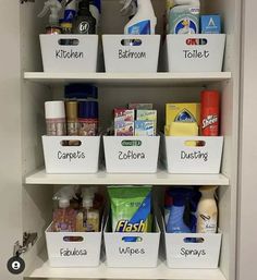 an organized pantry with white bins filled with cleaning products