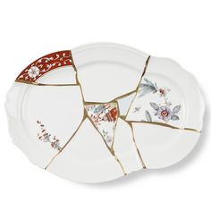 a broken plate with red and white designs on it