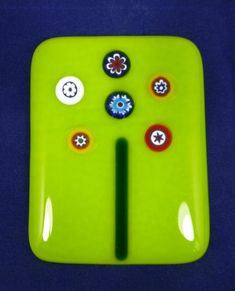 a close up of a green object with buttons on the front and back of it