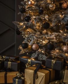 a christmas tree with presents under it