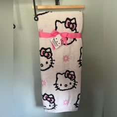 a hello kitty towel hanging on a clothes rack