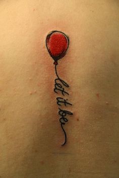 the back of a woman's shoulder with a balloon tattoo on it