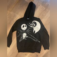 New Without Tags, Disney Kids Nightmare Before Christmas Hoodie Black, 100% Cotton Sweatshirt With Hood Size 14/16 White Print On Front, Plain Black Back Join Jack Skellington, The Pumpkin King, As He Stumbles From Halloween Town To Christmas Town And Becomes Awed By The Festive Winter Holiday. Help Jack, Sally, Zero The Dog, And The Other Citizens Of Halloween Town Celebrate And Successfully Take Over Christmas From Santa Clauswithout Getting Oogie Boogie Involved This Time! Get Your Little One Disney Style Sweatshirt With Character Print For Winter, Disney Character Print Sweatshirt For Winter, Disney Character Print Winter Sweatshirt, Disney Hoodie With Cartoon Print For Winter, Disney Style Winter Hoodie With Cartoon Print, Disney Cartoon Print Hoodie For Winter, Disney Cartoon Print Winter Hoodie, Black Disney Sweatshirt For Winter, Black Disney Winter Sweatshirt