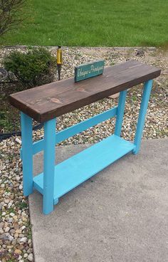 a blue bench sitting on top of a sidewalk