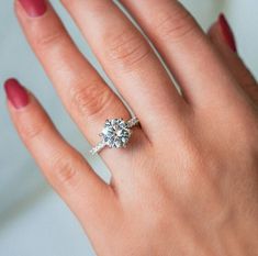 a woman's hand with a diamond ring on it