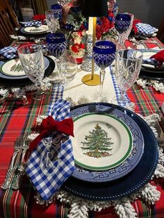 a christmas table setting with plates and place settings