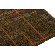 an area rug with different colors and designs on it, including squares and lines in the middle