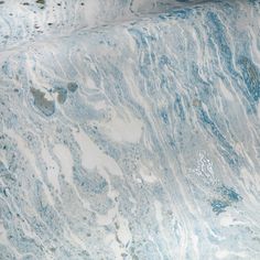 a blue and white marbled surface is shown in this image