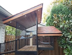 a bird cage sitting on top of a wooden deck