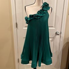 Brand New With Tags! Perfect Color For The Holidays! Beautiful Pleated Dress With Ruffle Details And Flowing Swing Skirt. There Is A Small Spot On The Ruffle Under One Arm (See Last Photo) - Likely Happened When Trying On And Likely Removable! Non Smoking Home. Green Pleated Party Dress, Green Pleated Mini Dress For Evening, Elegant Green Pleated Mini Dress, Green Pleated Mini Dress For Cocktail, Green Pleated Cocktail Mini Dress, Formal Green Mini Dress With Ruffles, Green Pleated Mini Dress For Spring, Green One-shoulder Pleated Dress, Green Pleated One-shoulder Dress