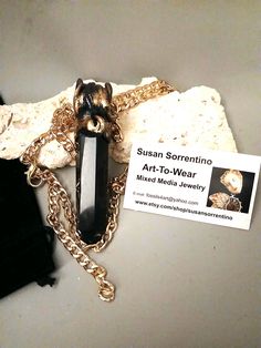 GREAT GIFT  HANDMADE art to wear JEWELRY by Susan Sorrentino Huge black Obsidian point pendant Art to Wear Hippie Jewelry  Grace and Frankie inspired   ooak  One of a kind good energy Pagan Natural stone Unisex necklace The pendant measures 1" x 4.5" 30" adjustable golden chain  One of a kind Amazing energy Art to Wear  Energy healing necklace that lays on the heart chakra. Healing of the Heart and LOVE concerns Attracts Love energy   Art to Wear Artist Statement: Susan Sorrentino I have been an Spiritual Black Jewelry With Large Pendant, Luxury Large Stone Spiritual Necklace, Luxury Black Spiritual Necklace, Spiritual Handmade Onyx Crystal Necklaces, Handmade Spiritual Onyx Crystal Necklace, Luxury Multi-stone Spiritual Necklace, Adjustable Obsidian Spiritual Necklace, Grace And Frankie, Heart Chakra Healing