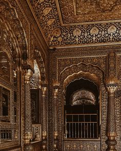 an ornately decorated room with iron railings and mirrors on the walls is shown in sepia