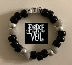 a black and white beaded bracelet with the words pierce veil written in letters on it