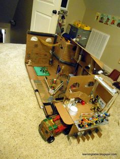 a cardboard box filled with toys on top of a kitchen counter