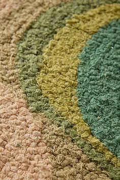 a close up view of a rug with different colors and shapes on the carpeting