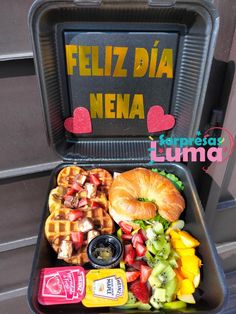 a lunch box with waffles, fruit and vegetables