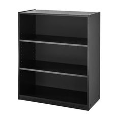 a black bookcase with three shelves on the bottom and one shelf below it, in front of a white background