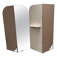 a white and tan display case next to a mirror