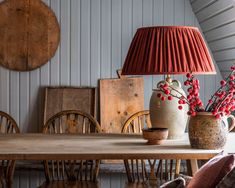 a table with two vases on it and a lamp in the middle next to it