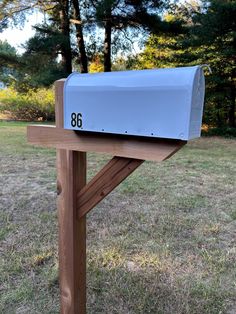 a mailbox sitting on top of a wooden post