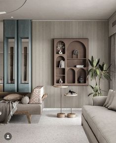 a living room filled with furniture next to a wall mounted book shelf on the side of a wall