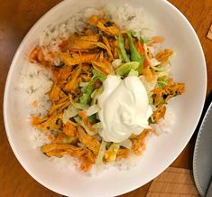 a white bowl filled with rice and meat