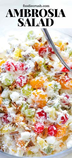 a close up of a salad in a glass bowl with a fork on the side