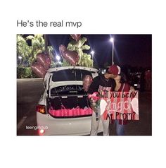 two people standing next to a car with balloons in the trunk and one holding a sign that says he's the real myp