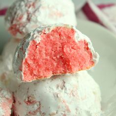 some pink and white desserts are stacked on top of each other in a bowl