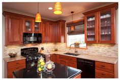 a kitchen with granite counter tops and wooden cabinets