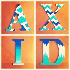 the letters are made out of wood and have different patterns on them, including blue and green