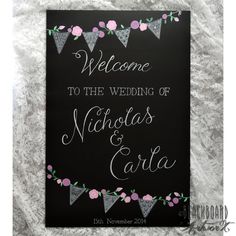 a welcome sign with bunting and flowers on it