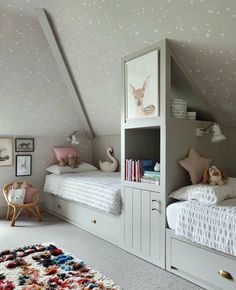 two children's beds in the corner of a room with stars on the walls