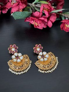 These unique ruby kundan chandbali Jhumka Earrings will certainly leave you spellbound. This pair of Jhumkas weighs about 1.4 oz.  If you are looking for an amazing trendy jumka for special occasions such as Anniversary, Engagement, Party, Wedding or for gifting , then these are a perfect choice.  Product care: Avoid contact with Chemicals such as Perfumes or any Sprays. Prevent the Jewellery from the water. Use Butter Paper or Cotton Cloth to store your Jewellery for a longer Product life. Cheap Festive Chandbali Jhumkas, Cheap Chandbali Jhumkas For Diwali, Temple Jewelry Pearl Chandbali Earrings With Meenakari, Heavy Temple Jewelry Pearl Earrings For Celebration, Traditional Chandbali Earrings For Eid, Eid Chandbali Earrings, Eid Anarkali Chandbali Danglers, Anarkali Chandbali Danglers For Eid, Festive Anarkali Chandbalis For Celebrations