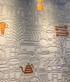 the wall is decorated with many different types of paper cutouts and designs on it