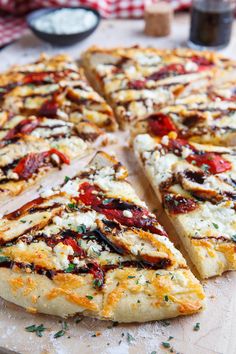 a pizza sitting on top of a wooden cutting board