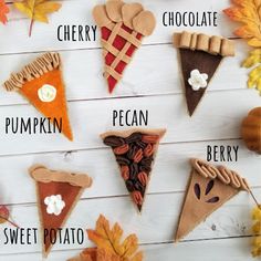 an assortment of different types of pies on a white surface with autumn leaves around them