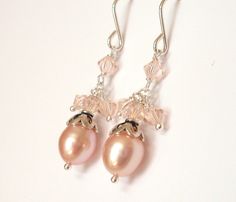 Delicate in pale peach, these earrings feature a beautiful freshwater pearl drop crowned with a scalloped Sterling Silver bead cap, below dangles of Swarovski crystal beads.  All metal is Sterling Silver. These lustrous pearls and sparkling Austrian crystals are a sweet and airy combination. The pearls are a warm natural peach pink. The crystals are the color Silk, a very pale peach.  Ball headpins for added detail and texture. The crystals are all 4mm in size. Two little dangles either side of a central crystal, a fourth one above.  The hooks are a simple sleek style. The earrings fall 1" (or 25mm) from the bottom of the hook. Code: E313ss To see other items in my shop, enter here: https://www.etsy.com/shop/ArtfulTrinkets1?ref=hdr_shop_menu PLEASE NOTE: Shipping to "everywhere else" will Elegant Apricot Dangle Earrings, Elegant Peach Pearl Jewelry, Elegant Apricot Dangle Jewelry, Elegant Apricot Earrings For Gift, Elegant Peach Dangle Earrings, Elegant Handmade Peach Jewelry, Elegant Apricot Jewelry For Wedding, Handmade Apricot Earrings Elegant Style, Handmade Elegant Apricot Earrings